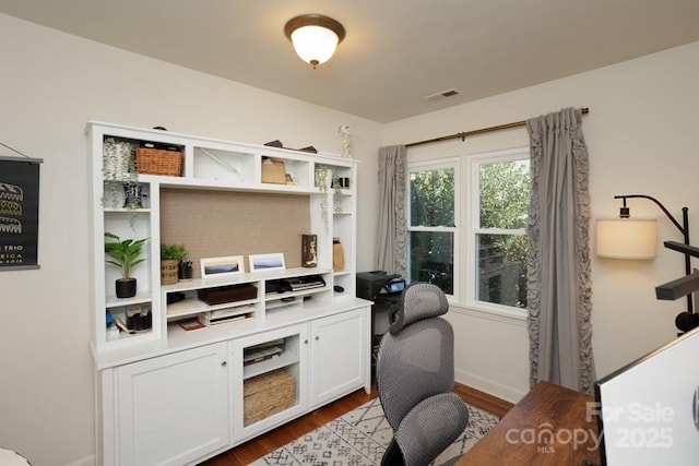 office area featuring dark wood finished floors and visible vents