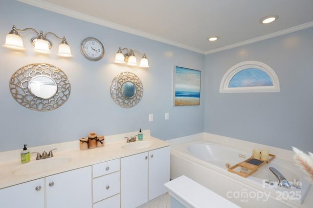 full bath featuring ornamental molding, a sink, a jetted tub, and double vanity