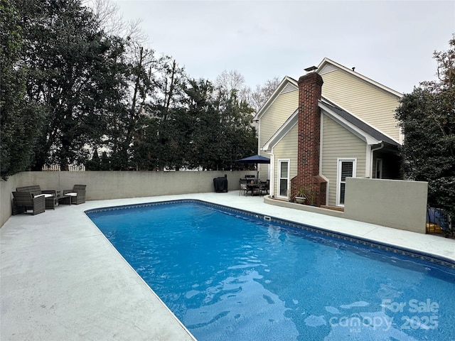 view of pool featuring a fenced in pool, a patio area, and fence