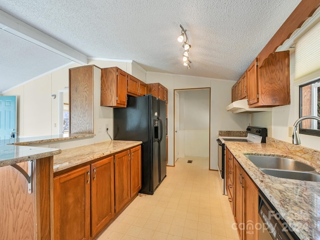 kitchen with sink, lofted ceiling with beams, a textured ceiling, and appliances with stainless steel finishes