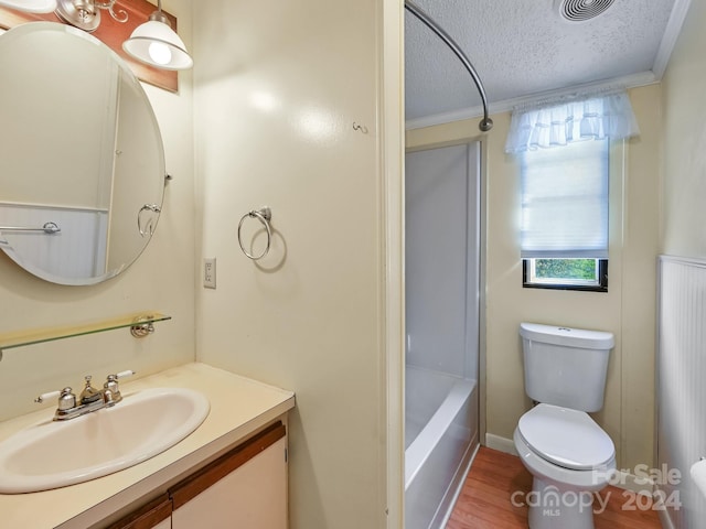 full bathroom with hardwood / wood-style flooring, toilet, a textured ceiling, and ornamental molding