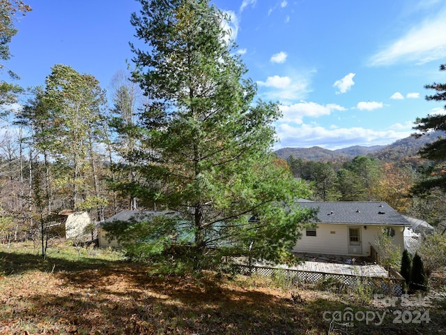 exterior space featuring a deck with mountain view