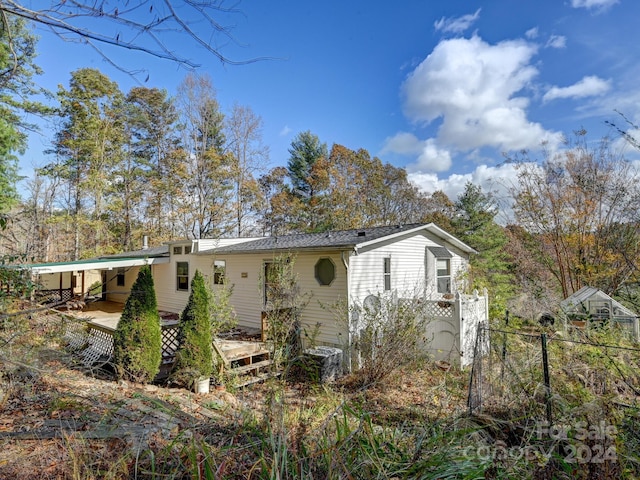 rear view of house with a wooden deck