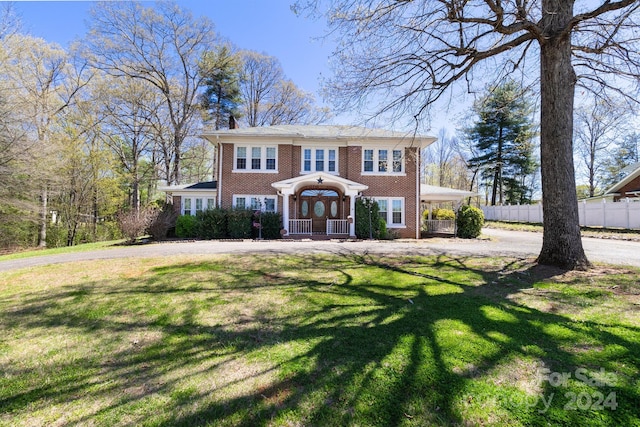 colonial inspired home with a front yard