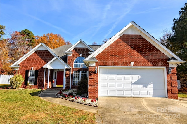 view of front of house with a garage and a front yard