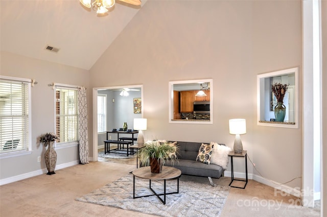 carpeted living room featuring ceiling fan and high vaulted ceiling