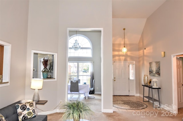 entryway with carpet flooring and high vaulted ceiling