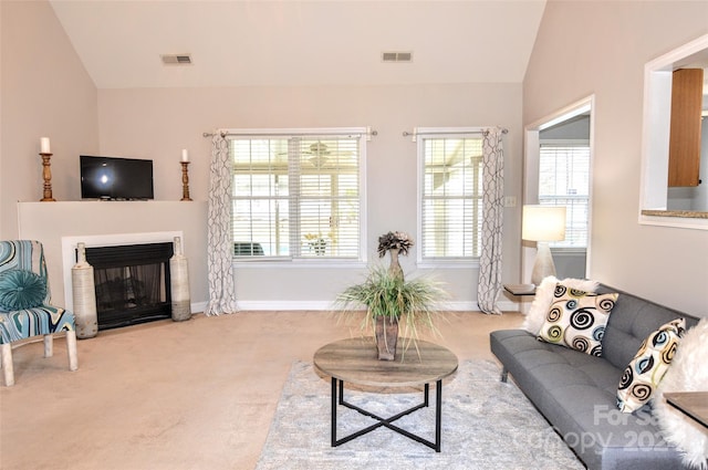 living room with light colored carpet and vaulted ceiling