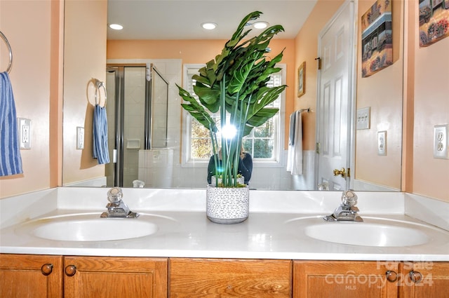 bathroom featuring vanity and an enclosed shower