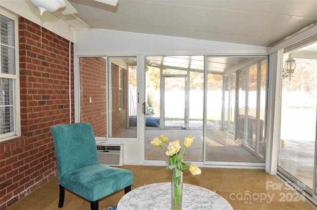 sunroom featuring ceiling fan and lofted ceiling