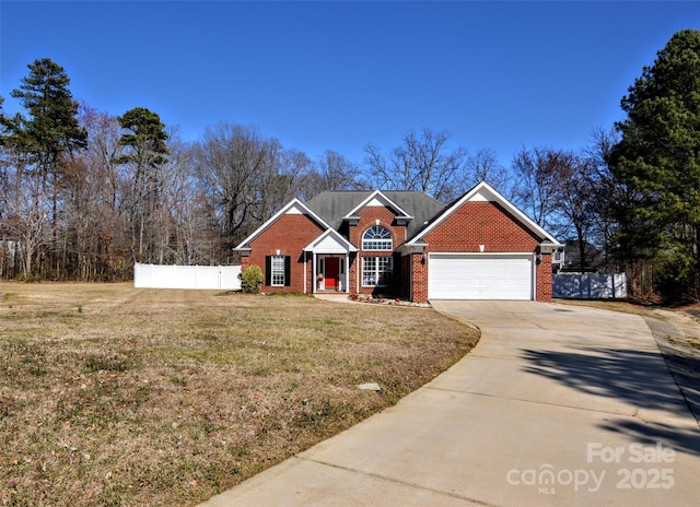 traditional home with driveway, brick siding, an attached garage, and fence