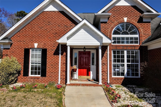 property entrance with brick siding