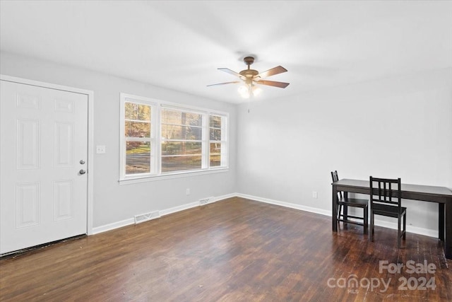 dining space featuring ceiling fan and dark wood-type flooring