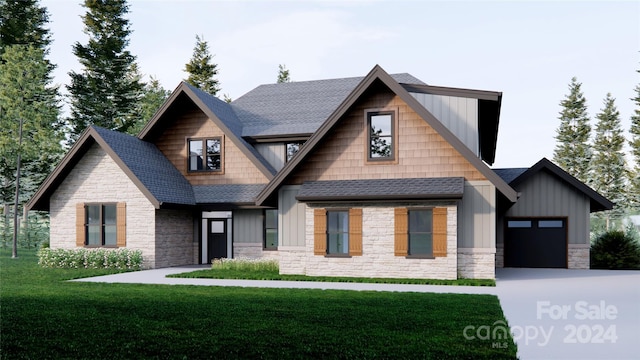 view of front of home featuring a garage and a front lawn