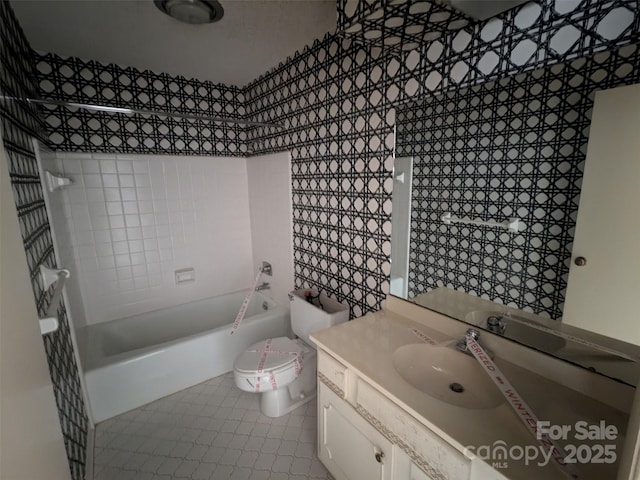 full bathroom featuring tiled shower / bath combo, vanity, tile patterned floors, and toilet