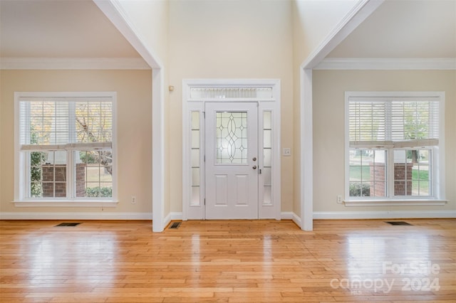 foyer featuring light hardwood / wood-style floors and ornamental molding