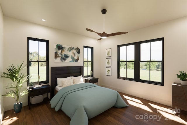 bedroom with ceiling fan, dark hardwood / wood-style floors, and multiple windows