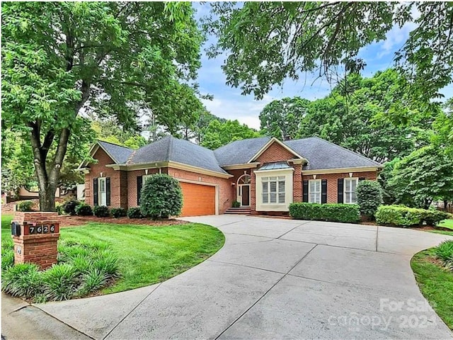 view of front of home with a garage and a front lawn