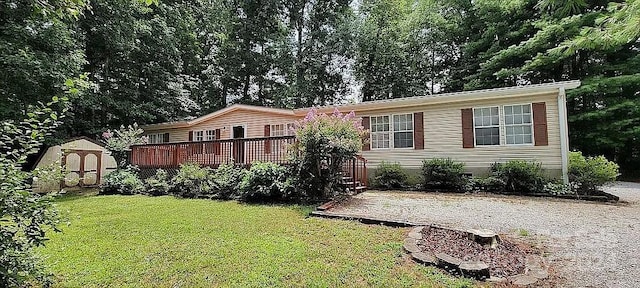 view of front facade featuring a front lawn, a deck, and a storage unit