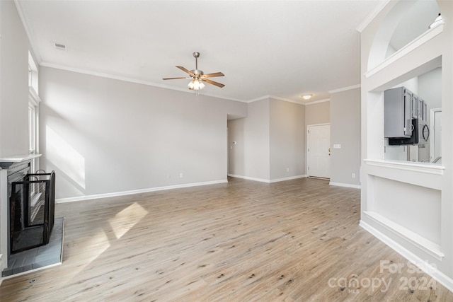 unfurnished living room featuring light hardwood / wood-style floors, ceiling fan, and crown molding