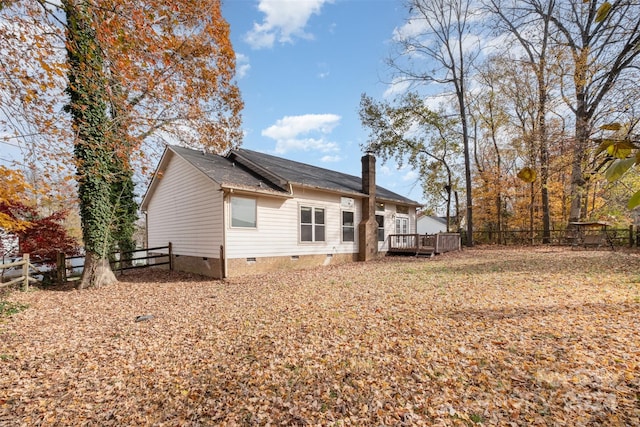 back of property featuring a wooden deck