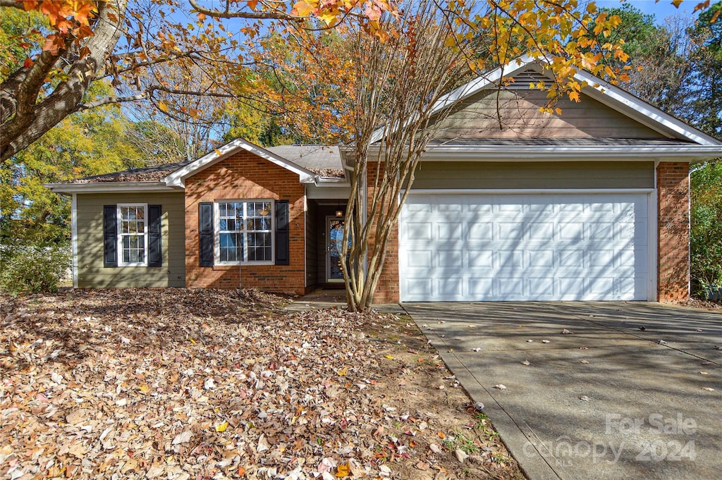 ranch-style house featuring a garage