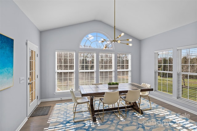 dining room featuring vaulted ceiling, dark hardwood / wood-style floors, and an inviting chandelier