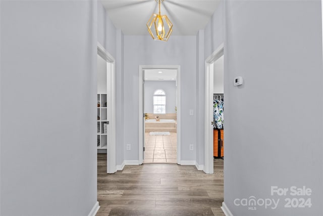 entrance foyer with hardwood / wood-style floors and an inviting chandelier