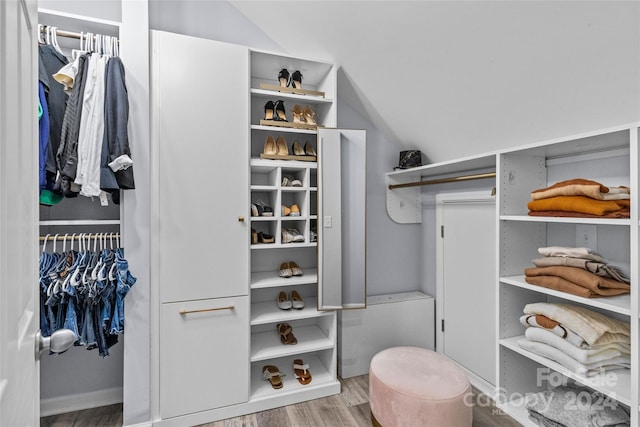 spacious closet featuring hardwood / wood-style flooring and lofted ceiling