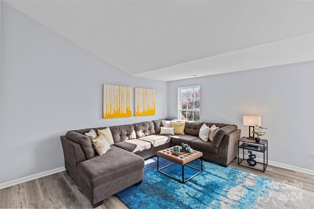 living room featuring hardwood / wood-style flooring and vaulted ceiling