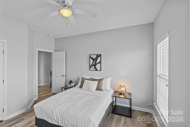 bedroom with hardwood / wood-style floors and ceiling fan