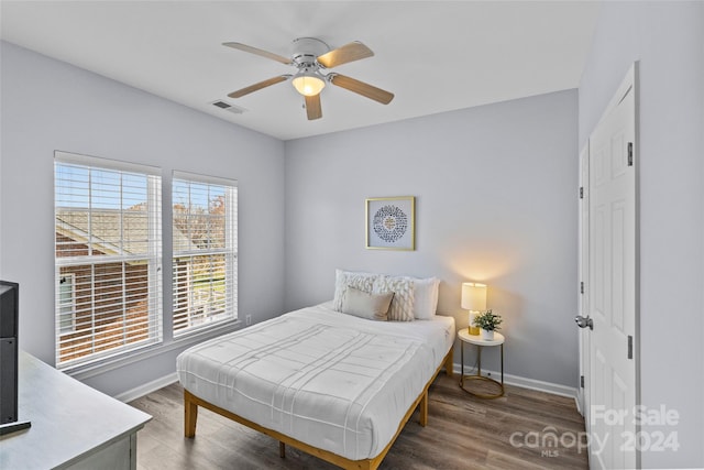 bedroom featuring ceiling fan and dark hardwood / wood-style floors