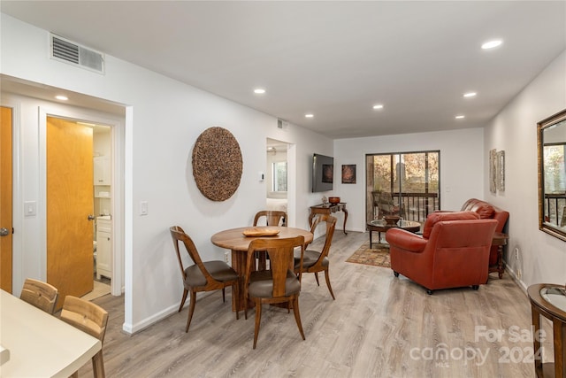 dining space featuring light wood-type flooring