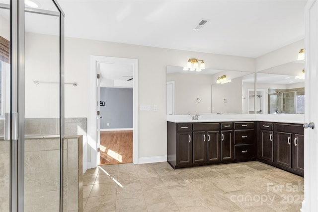 bathroom with tile patterned floors, walk in shower, and vanity