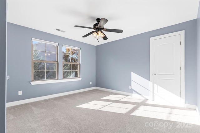 empty room with ceiling fan and light colored carpet