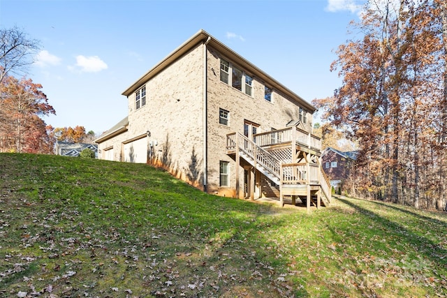 rear view of house with a deck and a lawn