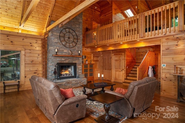 living room with wooden walls, high vaulted ceiling, wooden ceiling, beamed ceiling, and hardwood / wood-style floors