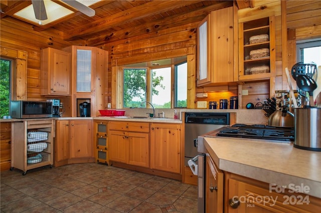 kitchen featuring wooden ceiling, sink, ceiling fan, beamed ceiling, and stainless steel appliances