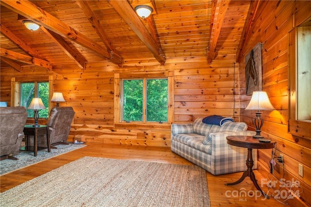 living room featuring wood-type flooring, wooden walls, vaulted ceiling with beams, and wooden ceiling