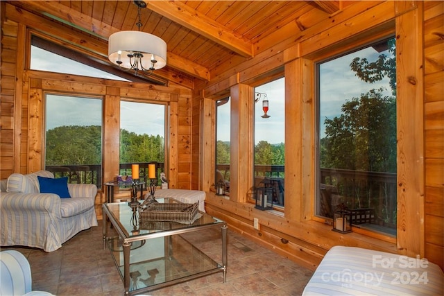 sunroom / solarium featuring lofted ceiling with beams, wooden ceiling, and a notable chandelier