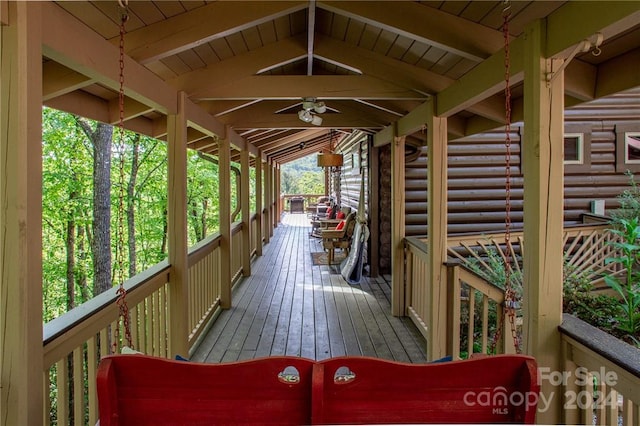 wooden terrace featuring ceiling fan and covered porch