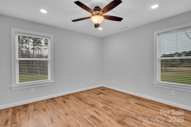 unfurnished room featuring visible vents, baseboards, recessed lighting, wood finished floors, and a ceiling fan