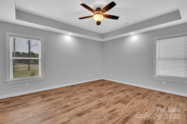 unfurnished room with visible vents, baseboards, recessed lighting, wood finished floors, and a ceiling fan