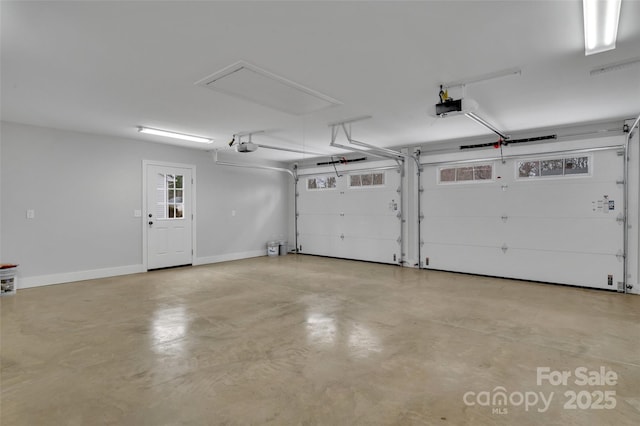 garage with a garage door opener and baseboards