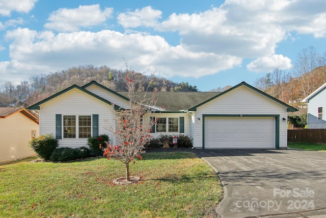 ranch-style house with a front yard and a garage