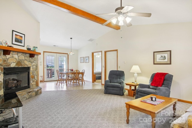 living room featuring hardwood / wood-style floors, high vaulted ceiling, a stone fireplace, ceiling fan, and beam ceiling