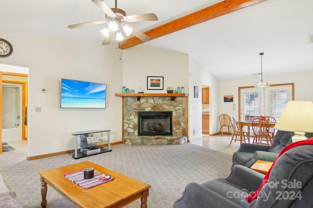 living room featuring vaulted ceiling with beams, light colored carpet, a stone fireplace, and ceiling fan