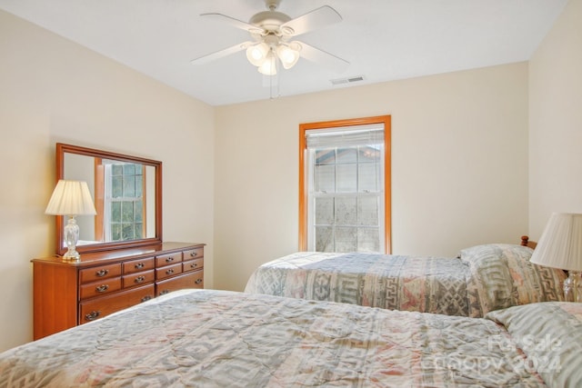 bedroom featuring multiple windows and ceiling fan