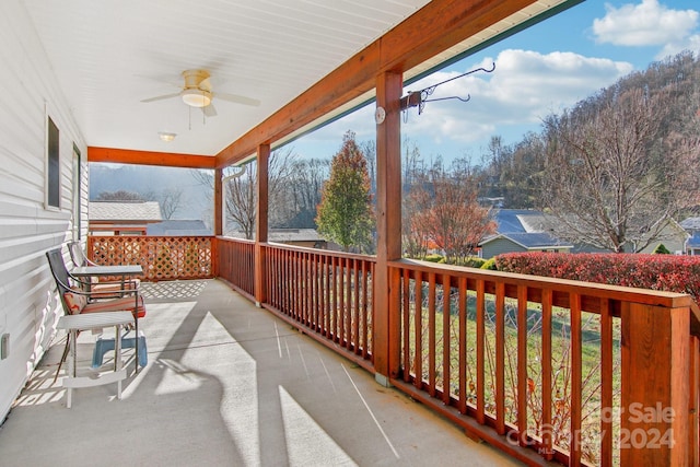 balcony featuring ceiling fan and a porch