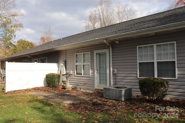 view of side of property with central AC unit